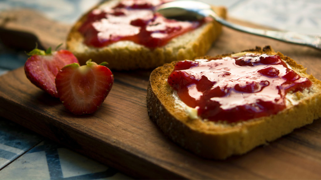 Strawberry jam slathered on toast. Homemade jam is an easy eco friendly gift idea