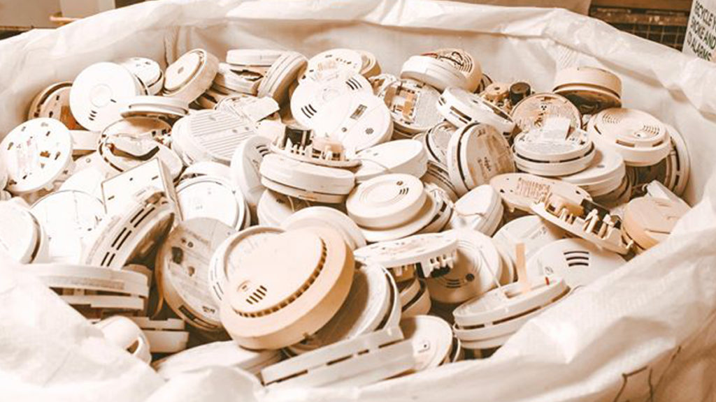 Pile of smoke alarms dropped off for recycling. Recycle unusual products like smoke alarms with our program