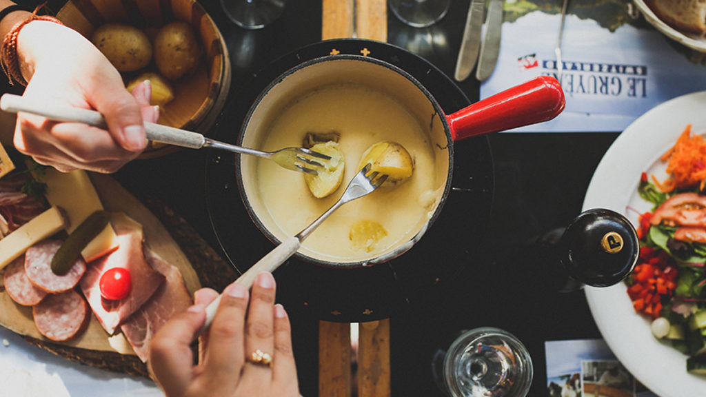 Dipping potatoes into cheese fondue. Fondue fuel is an unusual recyclable product