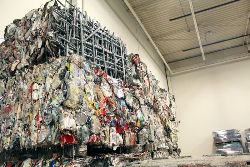 Large quantity of crushed metal paint cans at a paint recycling facility in Delta, BC, Canada