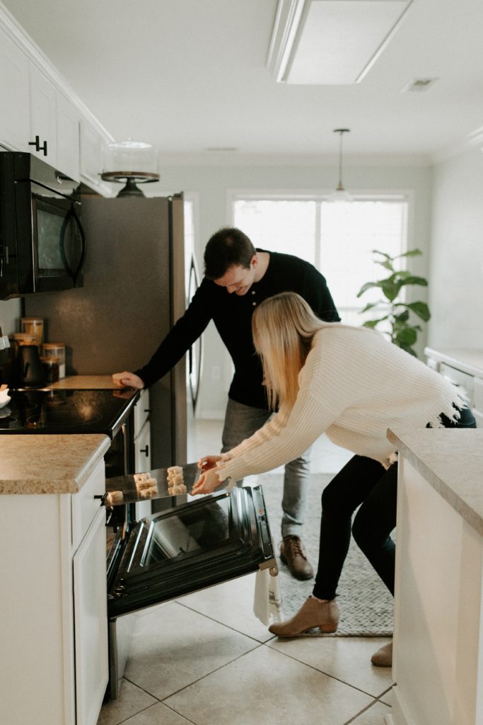 Couple saving energy by using the oven smart