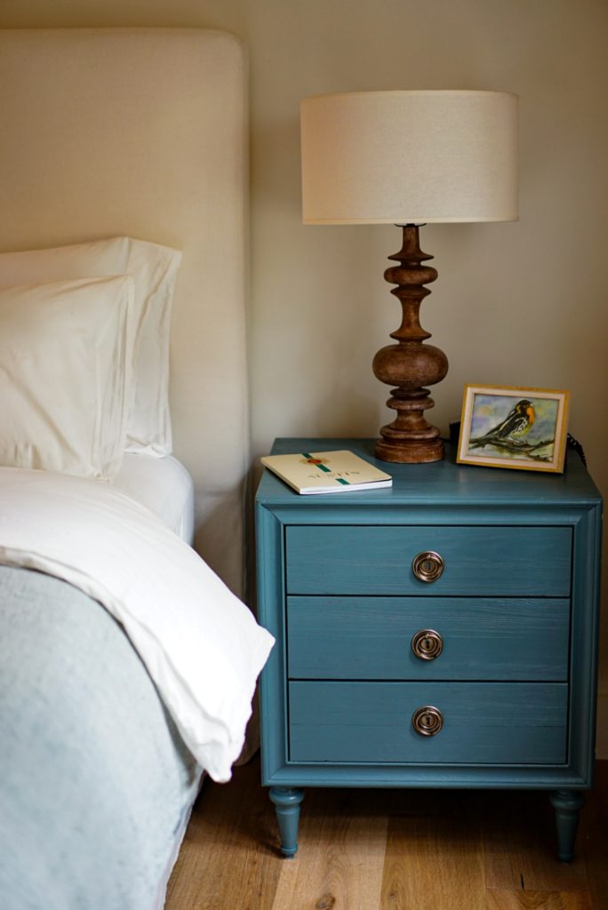 lamp and side table beside bed