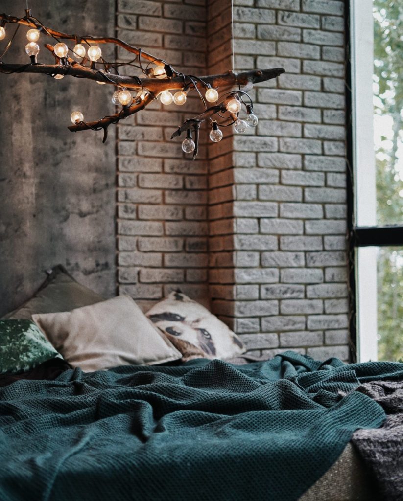 lights on branch on top of bed