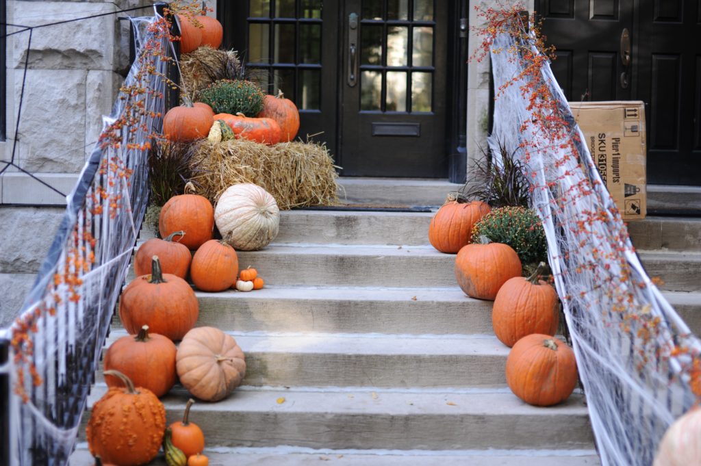 pumpkin and halloween decor on doorsteps
