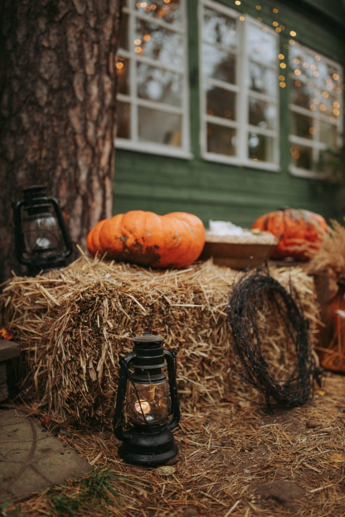 pumpkin and lantern on haystack