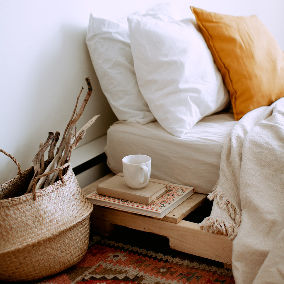 Cozy carpeted room with warm blankets and a mug