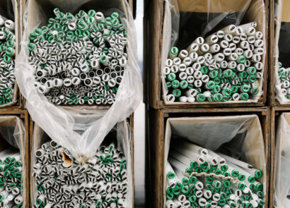 Fluorescent tubes sorted in recycling bulk bins.