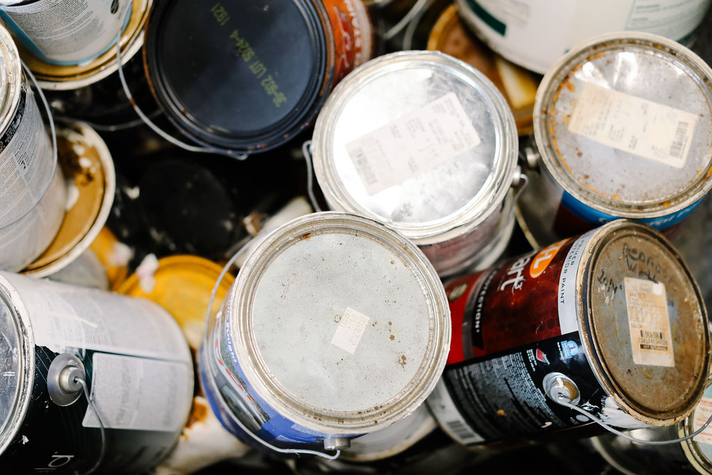 Assorted leftover paint cans available for reuse at a PaintShare collection site.
