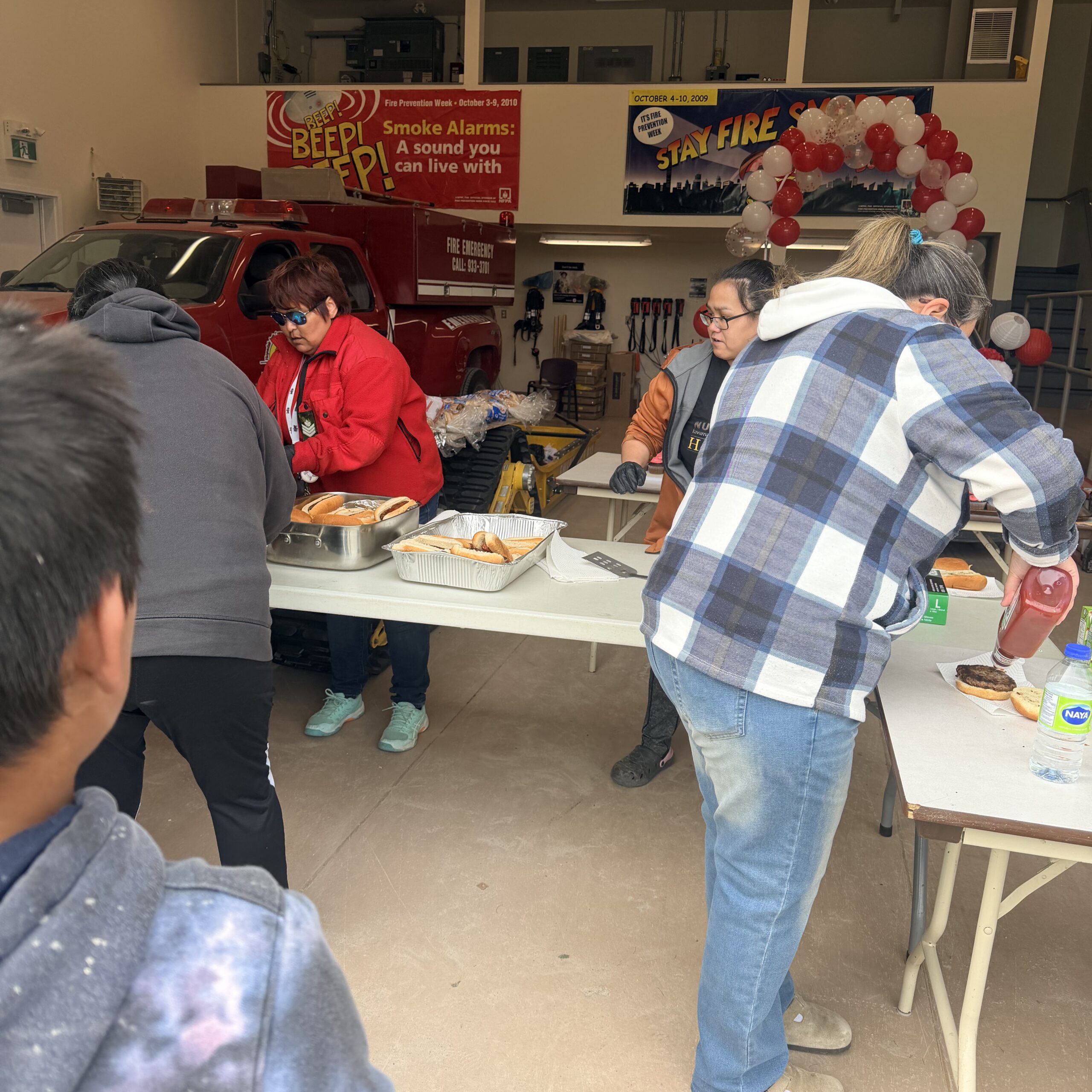 Volunteers serve hot dogs and drinks to residents during Hopedale’s Canada Day barbecue